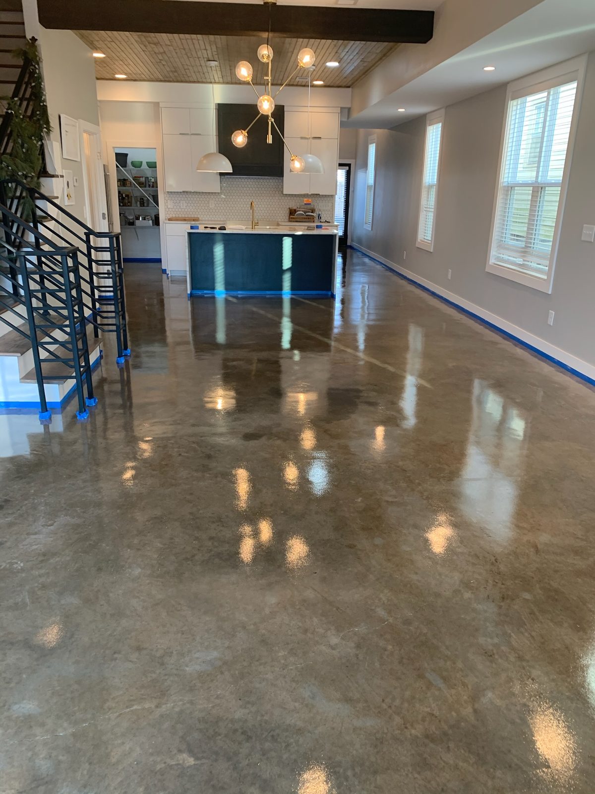 Patina custom-stained concrete floor in an open-plan main level — Nashville