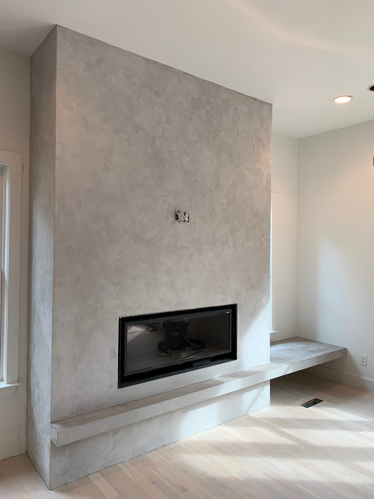 Velluto microcement fireplace surround detail with cantilevered bench — East Nashville