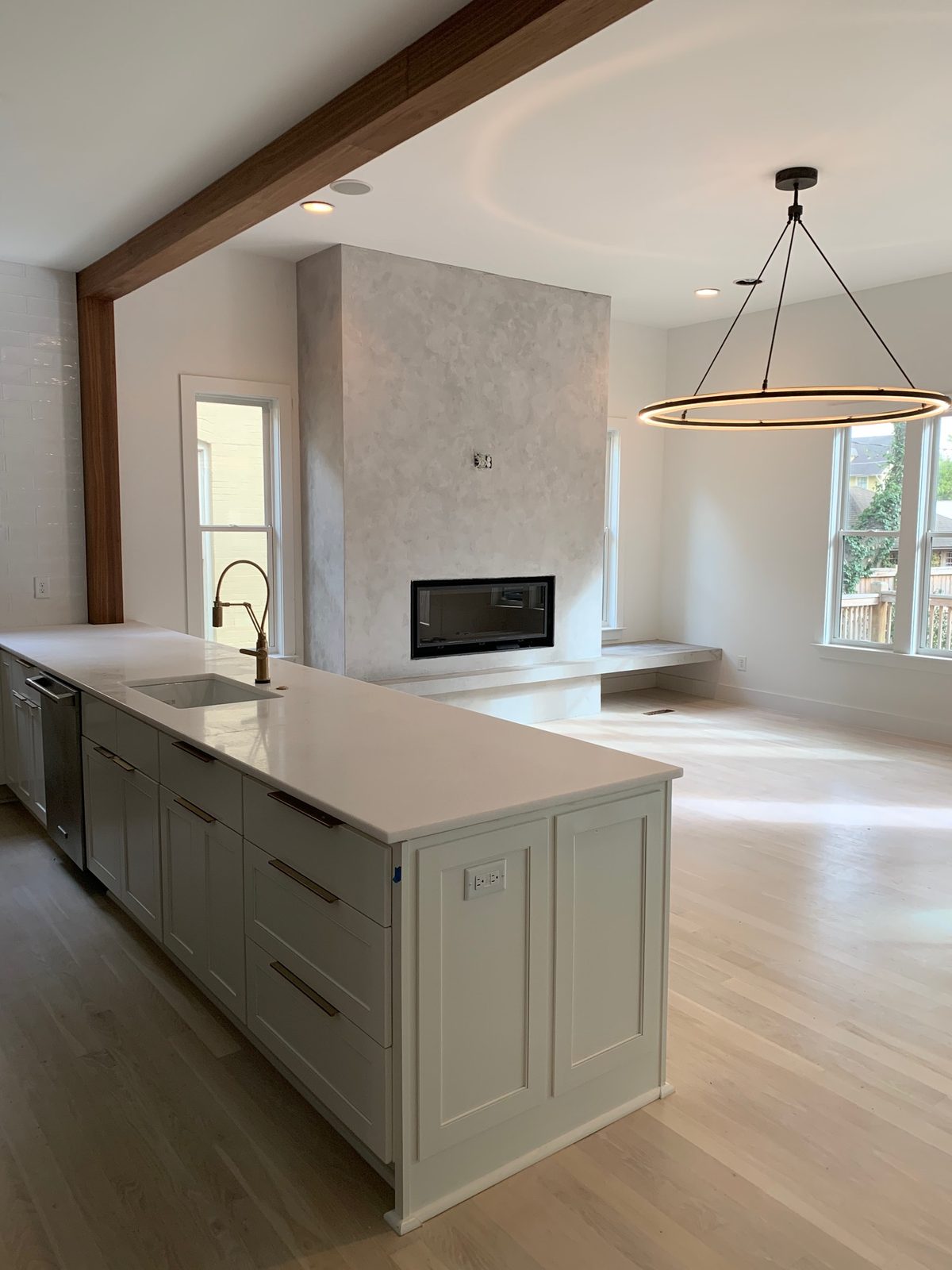 Velluto microcement fireplace anchoring an open kitchen and living space — East Nashville