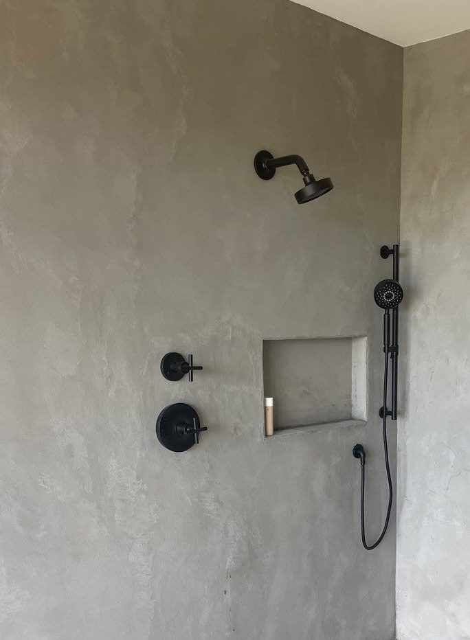 Velluto microcement shower walls with matte black fixtures — Charlotte
